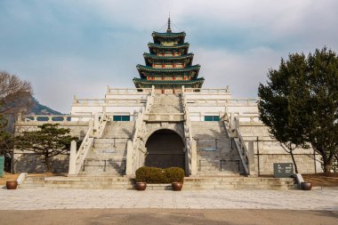 Scenic view of the five-story pagoda at the National Folk Museum of Korea in Seoul, framed by trees and winter landscape.