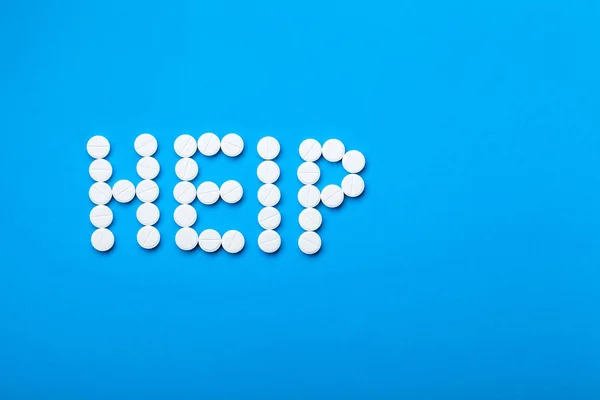 Help Van Word Voor Witte Tabletten Blauw Papier Achtergrond Met — Stockfoto