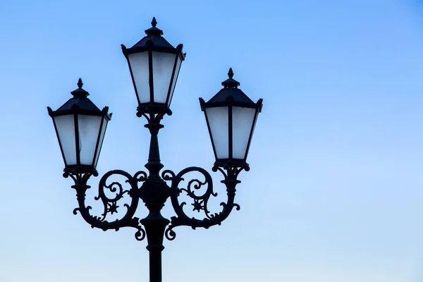 青い空を背景黒の街路灯 ガラスインサート つの錬鉄のランプの街灯のシルエット — ストック写真
