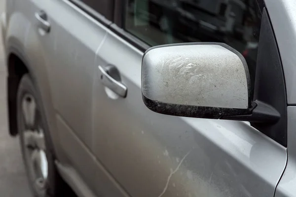 rear view mirror of a dirty car.
