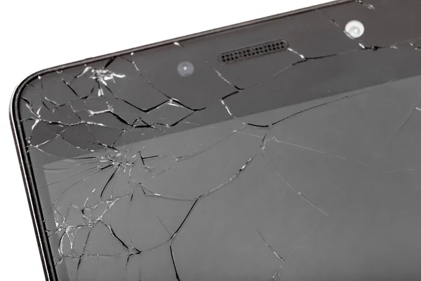 Broken glass of smartphone screen close-up of cracks.