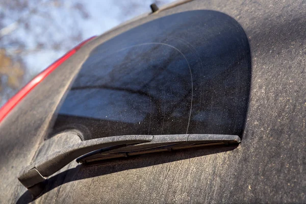 Close up of a dirty car wiper on a dirty back window in mud and divorce.