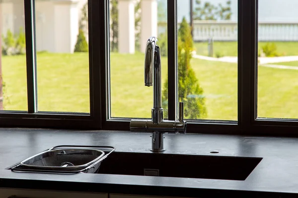 Chromed Faucet Kitchen Sink Black Stone Tabletop Window View Yard Stock Photo