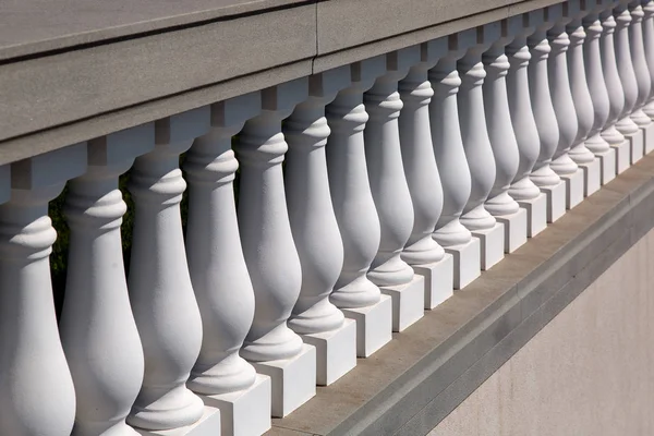 Baroque architecture details of stone white balustrades close up on sunny day.