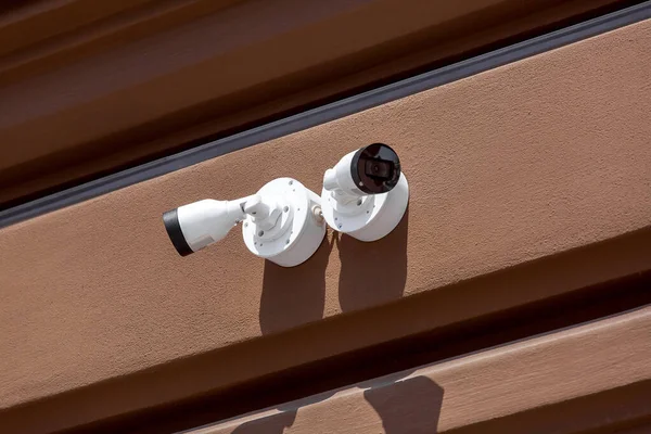 Две Белые Камеры Видеонаблюдения Установлены Внешнем Фасаде Коричневой Стены Закрывают — стоковое фото
