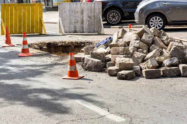 The road repair work and caution with blocked barrier protecting road traffic from the danger of hitting an obstacle,  over concrete digging.