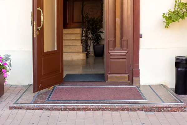 a threshold on entrance door with a handle in the hotel on facade of building close up architecture details, european cityscaep nobody.