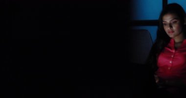 Arkadaşlarıyla sohbet ederken gülümseyen genç bir kadın.