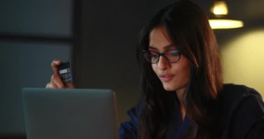 Ödeme bildirimi için telefonunu kontrol ederken gülümseyen kadın