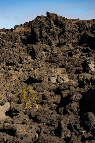 Black volcanic rock formation with blue sky on Lanzarote Island