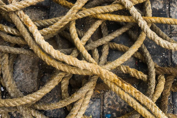 Nautical rope tangled on stone ground from above
