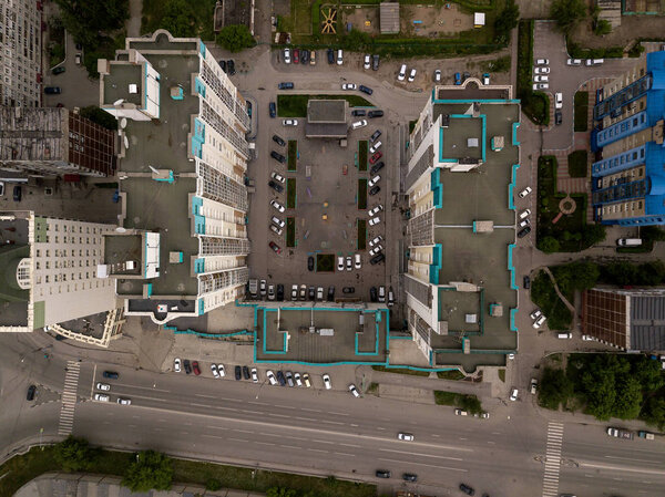Aerial View of n-shaped skyscraper with parking cars in the city. Dachnaya street, Novosibirsk.