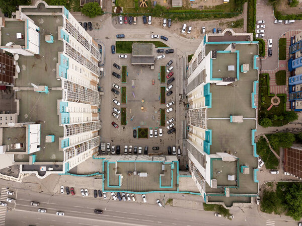 Aerial View of n-shaped tall buildangs with parking cars in the city. Dachnaya street, Novosibirsk.