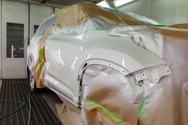 Beyaz boya teknolojisiyle boya tabancası ile iş sınıfı crossover presale hazırlık bir profesyonel oto tamircisi pahalı bir Suv araç hasarlı ön kısmını yeniden.