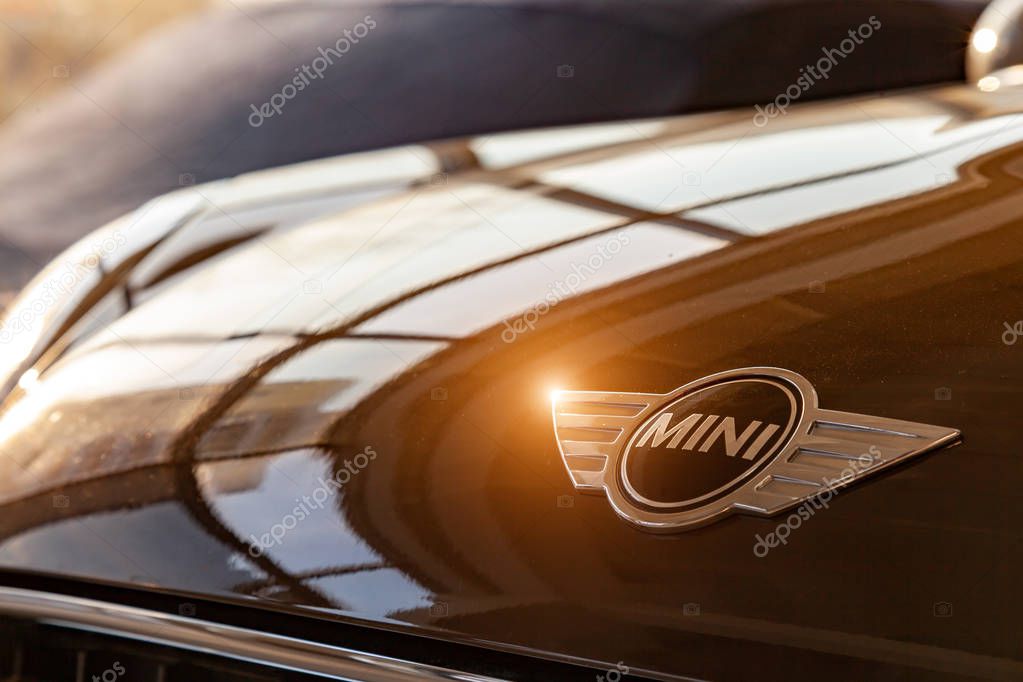 Novosibirsk, Russia - 08.01.2018: A close-up logo with a mini black metal chrome image on a brown shiny hood in the sunlight of a brown car as a symbol of an expensive brand.