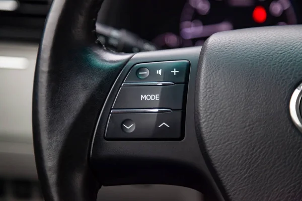 Music control buttons via bluetooth on the steering wheel of the car close-up, \