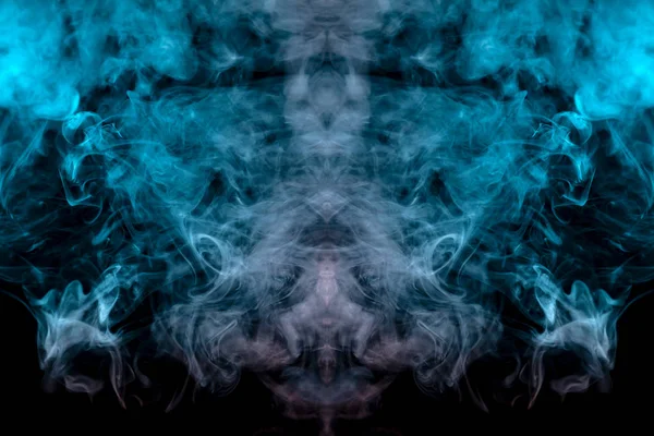 Abstract pattern of colored smoke backlit blue, green and turquoise in the shape of a mystical-looking bird or a ghost-head on a black isolated background. Soul and inner state of thoughts.