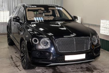 Novosibirsk, Rusya - 08.01.18: Ön görünümü lüks çok pahalı yeni siyah Bentley Bentayga araba tribünlerde Oto Servisi tamir bekliyor çamaşır kutusu