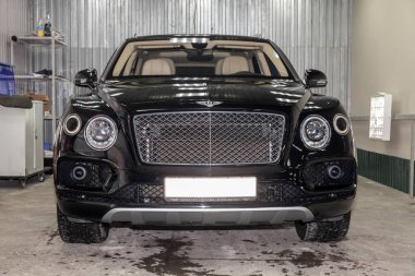 Novosibirsk, Rusya - 08.01.18: Ön görünümü lüks çok pahalı yeni siyah Bentley Bentayga araba tribünlerde Oto Servisi tamir bekliyor çamaşır kutusu