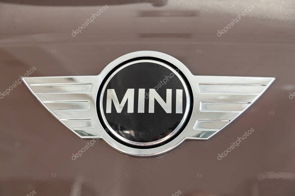Novosibirsk, Russia - 08.01.2018: A stylish chrome-plated shiny brand logo on a polished light-reflecting bonnet of an expensive vehicle with a mini Cooper model close-up. Manufacturer Sign.