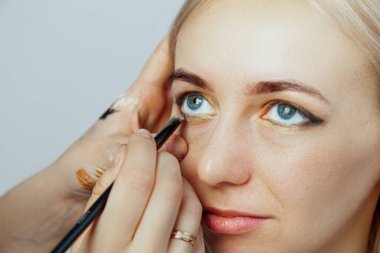 Bir yandan göze makyaj fırçası ile Visagiste