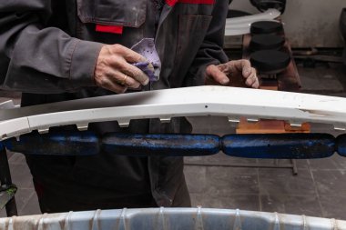 Bir adam boyama bir kazadan sonra bir araba body öğesi hazırlar