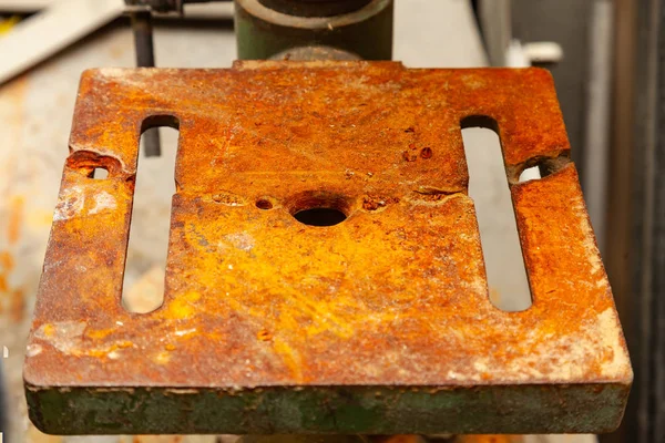 An iron plate with holes covered with a thick layer of rust that — Stock Photo, Image