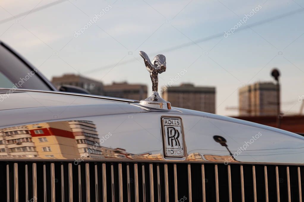 Novosibirsk, Russia - 04.11.2019: Front view of emblem Spirit of Ecstasy of new a very expensive Rolls Royce Phantom car, a long black limousine, model outdoors on parking