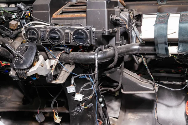 Car interior in the back of a van with a disassembled dashboard — Stock Photo, Image