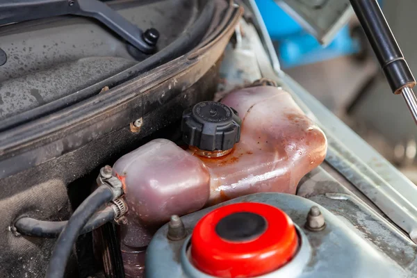 Coolant tank stained with oil with a level sensor and wires elec — Stock Photo, Image