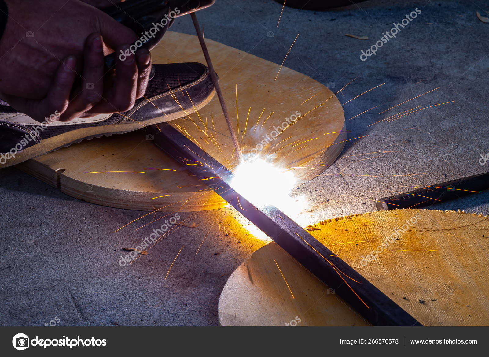 Close Up View Strong Man Is A Welder In Blue Working Overalls Wi