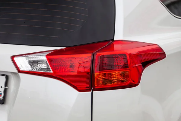 Close-up pada lampu rem belakang warna merah pada mobil putih di — Stok Foto