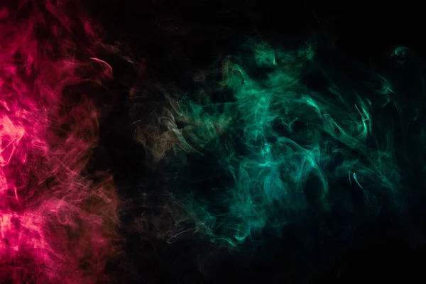 Beautiful column of smoke in the neon bright light of red, green