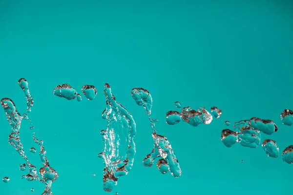 Water droplets frozen in the air with splashes and chain bubbles