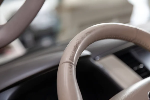 Car interior with a beige leather steering wheel close-up which — Stock Photo, Image
