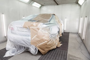 Büyük bir gümüş sedan araba tamamen kağıt ve yapıştırıcı kaplıdır