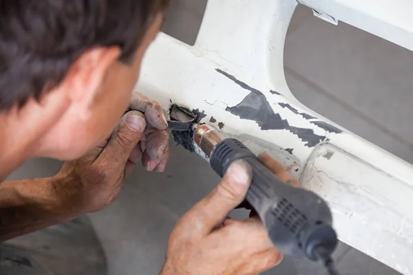 Man worker with Industrial soldering gun of black color on the f