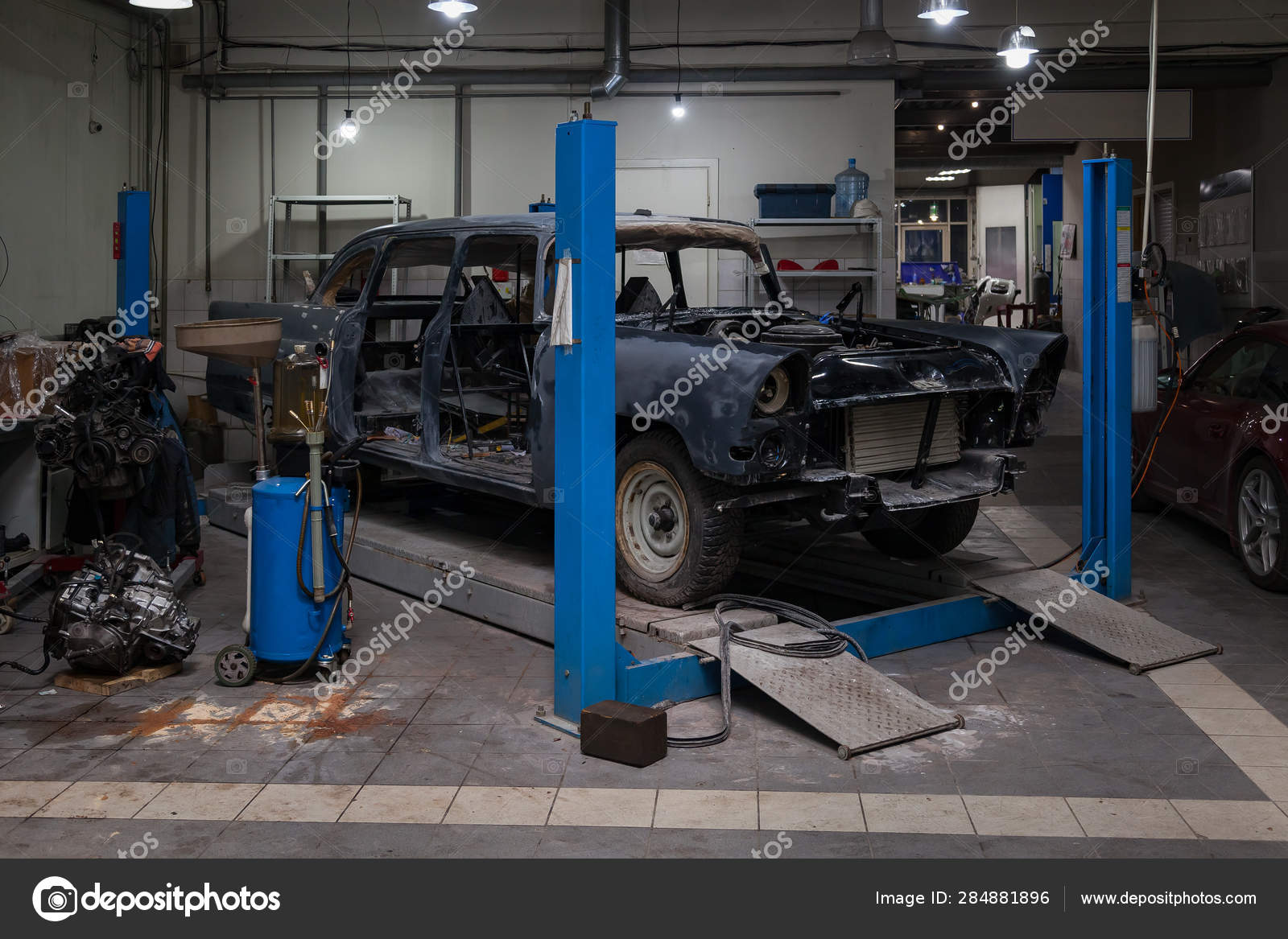 An Old Classic Retro Car Of Black Color Stands On A Blue Lift Fo Stock Photo By C Aleksandrkondratov 284881896