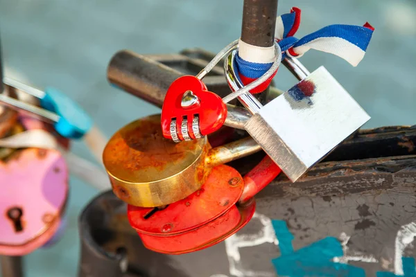 Close-up on locks of hearts in different colors and shapes hangi