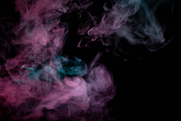 Colored background with winding clouds of smoke from patterns of different forms of pink, green and blue colors with tongues of flame on a black isolated background. Print for t-shirt.