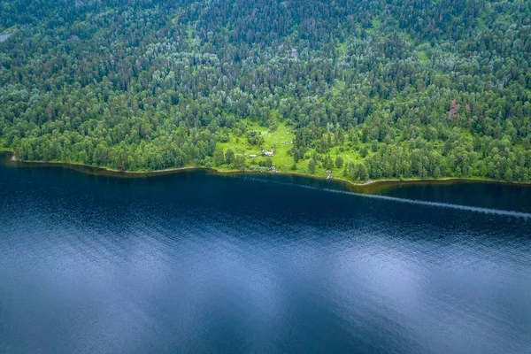 Small alone house in the Teletskoe Lake at the Altai Mountains n