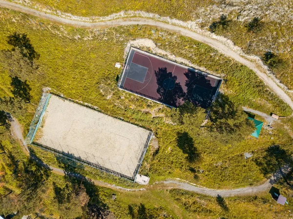 Aerial view on two sports fields for football and basketball in