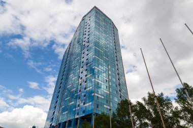 Yansıtan aynalı pencereleri olan yüksek bir binada yakın çekim