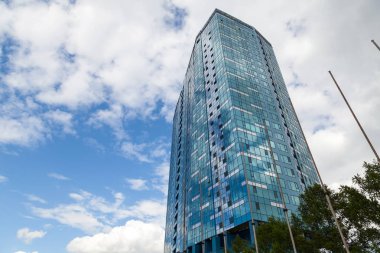 Yansıtan aynalı pencereleri olan yüksek bir binada yakın çekim