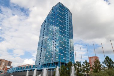 Yansıtan aynalı pencereleri olan yüksek bir binada yakın çekim