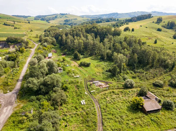 Aerial top view of a settlement in the Altai Mountains with smal