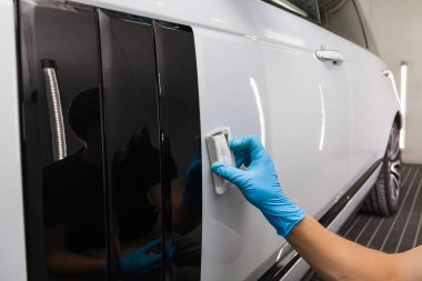 The process of applying a nano-ceramic coating on the white car'