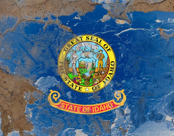 Idaho grunge, damaged, scratch, old style state flag on wall. — Stock Photo, Image