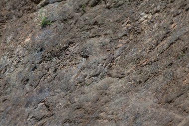 Gri ve kahverengi renkli taştan yapılmış kaba bir arkaplan