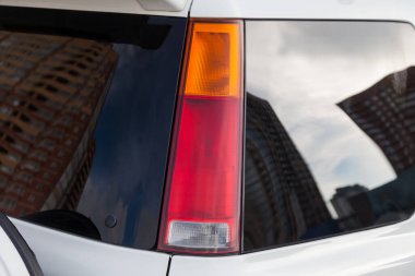Kırmızı bir LED arka fren lambasının yakın çekimi, satış öncesi hazırlık için yıkama ve temizlik yaptıktan sonra bir SUV 'un arkasındaki beyaz bir arabaya çarptıktan sonra değiştirildi. Fren lambalı stop lambaları.